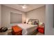 Neutral bedroom with a cozy bed, a fan, and a brightly-painted bedside table at 10287 Sw 96Th Ln, Ocala, FL 34481