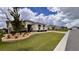 A well-kept lawn highlights this home, featuring a paver driveway and tasteful exterior window design at 10287 Sw 96Th Ln, Ocala, FL 34481