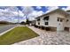 Charming home featuring a paver driveway, manicured landscaping, and stylish exterior window shades at 10287 Sw 96Th Ln, Ocala, FL 34481