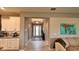 Welcoming foyer features tile floors and a modern white front door, connecting to kitchen and living area at 10287 Sw 96Th Ln, Ocala, FL 34481
