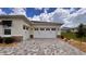 Spacious three-car garage with paver driveway, perfect for car enthusiasts or extra storage at 10287 Sw 96Th Ln, Ocala, FL 34481