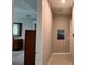 Hallway featuring neutral paint and baseboards, with artwork hung on the walls at 10287 Sw 96Th Ln, Ocala, FL 34481