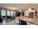 Bright, open kitchen with granite countertop island and views into the dining area at 10287 Sw 96Th Ln, Ocala, FL 34481