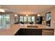 Bright, open kitchen with a granite countertop island and views into dining area at 10287 Sw 96Th Ln, Ocala, FL 34481