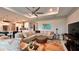 Cozy living room area featuring a large sofa and access to the kitchen area at 10287 Sw 96Th Ln, Ocala, FL 34481