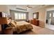 Main bedroom features a ceiling fan and an accent wall, with an ensuite bathroom at 10287 Sw 96Th Ln, Ocala, FL 34481