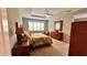 Bedroom with a ceiling fan, a window with blinds, and decorative furniture at 10287 Sw 96Th Ln, Ocala, FL 34481