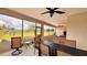 Screened-in patio features an outdoor dining area with ceiling fans, providing a comfortable space for enjoying the view at 10287 Sw 96Th Ln, Ocala, FL 34481