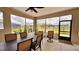 Inviting patio with outdoor seating, dining area, and ceiling fans, offering a relaxing space to enjoy the fresh air at 10287 Sw 96Th Ln, Ocala, FL 34481
