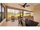 Enclosed patio area showcases views of the yard with comfortable seating and dining, perfect for relaxing or entertaining guests at 10287 Sw 96Th Ln, Ocala, FL 34481