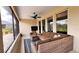 Relaxing screened-in patio features comfortable seating and a ceiling fan at 10287 Sw 96Th Ln, Ocala, FL 34481