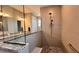 Sleek shower with mosaic tile floor, glass enclosure, and rainfall shower head, designed for a modern and luxurious bathroom experience at 10287 Sw 96Th Ln, Ocala, FL 34481