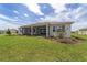 A screened-in porch and landscaping enhances this home's backyard, great for relaxation and entertaining at 10553 Sw 98Th Pl, Ocala, FL 34481
