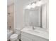 Bright bathroom featuring a white vanity, large mirror, and combined tub and shower at 10553 Sw 98Th Pl, Ocala, FL 34481