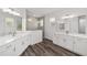 Modern bathroom with double vanities, sleek fixtures, and a glass-enclosed shower for a spa-like experience at 10553 Sw 98Th Pl, Ocala, FL 34481