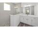 A bathroom features a glass shower, grey tiles, and a white vanity with storage at 10553 Sw 98Th Pl, Ocala, FL 34481