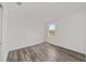 A bedroom features hardwood flooring, a large window, and a neutral color scheme at 10553 Sw 98Th Pl, Ocala, FL 34481