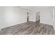 Spacious bedroom with wood-look flooring and multiple doorways leading to other areas of the house at 10553 Sw 98Th Pl, Ocala, FL 34481