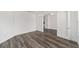An open bedroom has hardwood flooring and a glass french door that lets in tons of light at 10553 Sw 98Th Pl, Ocala, FL 34481