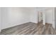 A bedroom has hardwood floors, a view of the bathroom, and an open door to hallway at 10553 Sw 98Th Pl, Ocala, FL 34481