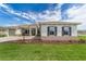 Inviting single-Gathering home featuring manicured green lawn and gray trim at 10553 Sw 98Th Pl, Ocala, FL 34481