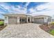 Suburban home with three-car garage, stone driveway, and manicured landscaping at 10553 Sw 98Th Pl, Ocala, FL 34481