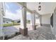 Classic covered porch supported by prominent columns and elegant lighting at 10553 Sw 98Th Pl, Ocala, FL 34481