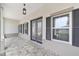 Welcoming covered porch with stone flooring, overhead lighting, and decorative windows at 10553 Sw 98Th Pl, Ocala, FL 34481