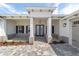 Inviting front porch with stone walkway, columns, and double glass doors at 10553 Sw 98Th Pl, Ocala, FL 34481