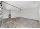 A large empty garage with a concrete floor, white walls, and a garage door at 10553 Sw 98Th Pl, Ocala, FL 34481