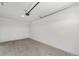 Empty garage featuring a concrete floor, white walls, and a service door at 10553 Sw 98Th Pl, Ocala, FL 34481