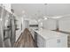 Modern kitchen with a large center island, stainless steel appliances, and pendant lighting at 10553 Sw 98Th Pl, Ocala, FL 34481