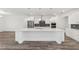 Bright kitchen features a large island, stainless steel appliances, and pendant lighting for a modern feel at 10553 Sw 98Th Pl, Ocala, FL 34481