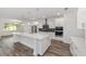 Stylish kitchen boasts a spacious island, white cabinetry, and stainless steel appliances for culinary enthusiasts at 10553 Sw 98Th Pl, Ocala, FL 34481