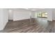 Spacious living room with wood-look floors and sliding glass doors at 10553 Sw 98Th Pl, Ocala, FL 34481