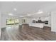 Open concept living space with modern kitchen and access to outdoor living at 10553 Sw 98Th Pl, Ocala, FL 34481