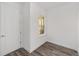 An empty room featuring luxury vinyl plank flooring, a window, and a white door at 10553 Sw 98Th Pl, Ocala, FL 34481