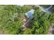 Aerial view of a quaint home surrounded by lush greenery and mature trees at 1322 Ne 53Rd St, Ocala, FL 34479
