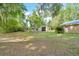 Large lot with mature trees and shrubs with small buildings in the backyard at 1322 Ne 53Rd St, Ocala, FL 34479