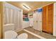 Functional basement bathroom featuring a shower, toilet, sink and washer and dryer at 1322 Ne 53Rd St, Ocala, FL 34479