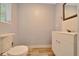 Simple, functional bathroom with light blue walls, tiled flooring and a white vanity at 1322 Ne 53Rd St, Ocala, FL 34479