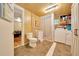 Functional bathroom with a toilet, sink, shower, and laundry area, designed for convenience and practicality at 1322 Ne 53Rd St, Ocala, FL 34479