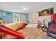 Playful bedroom with colorful Lion King poster, a wood floor, and outdoor view at 1322 Ne 53Rd St, Ocala, FL 34479
