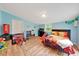 Cozy bedroom with a sloped ceiling, wood floors, and colorful decor, perfect for a  at 1322 Ne 53Rd St, Ocala, FL 34479