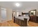 Spacious bedroom featuring a large bed, wood floors, and adjoining bathroom at 1322 Ne 53Rd St, Ocala, FL 34479
