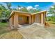 Exterior shot of single story home with carport, front door and partial lawn at 1322 Ne 53Rd St, Ocala, FL 34479