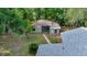Aerial view of a detached garage featuring a gated entry, a small door and window with surrounding greenery at 1322 Ne 53Rd St, Ocala, FL 34479