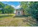 View of the front door of a tan one-story home surrounded by a lawn at 1322 Ne 53Rd St, Ocala, FL 34479