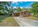 Exterior view of a one-story home with a carport and long driveway at 1322 Ne 53Rd St, Ocala, FL 34479