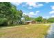 A charming one-story home with a large front yard and mature trees at 1322 Ne 53Rd St, Ocala, FL 34479